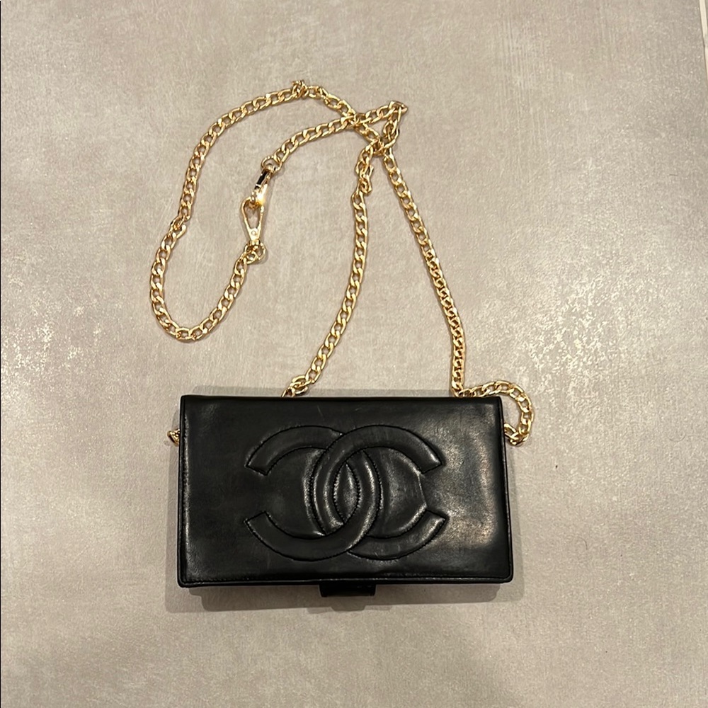 CHANEL Black and Gold Clutch with Embossed CC Logo